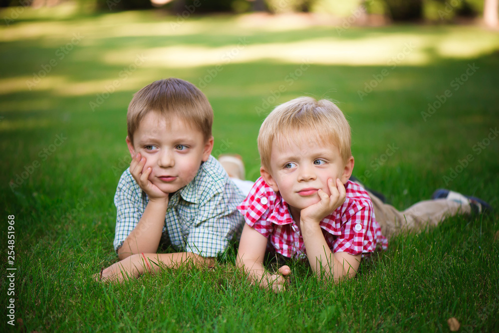 Two young boys walk and relax in the park. Two young boys walk and relax in the park.