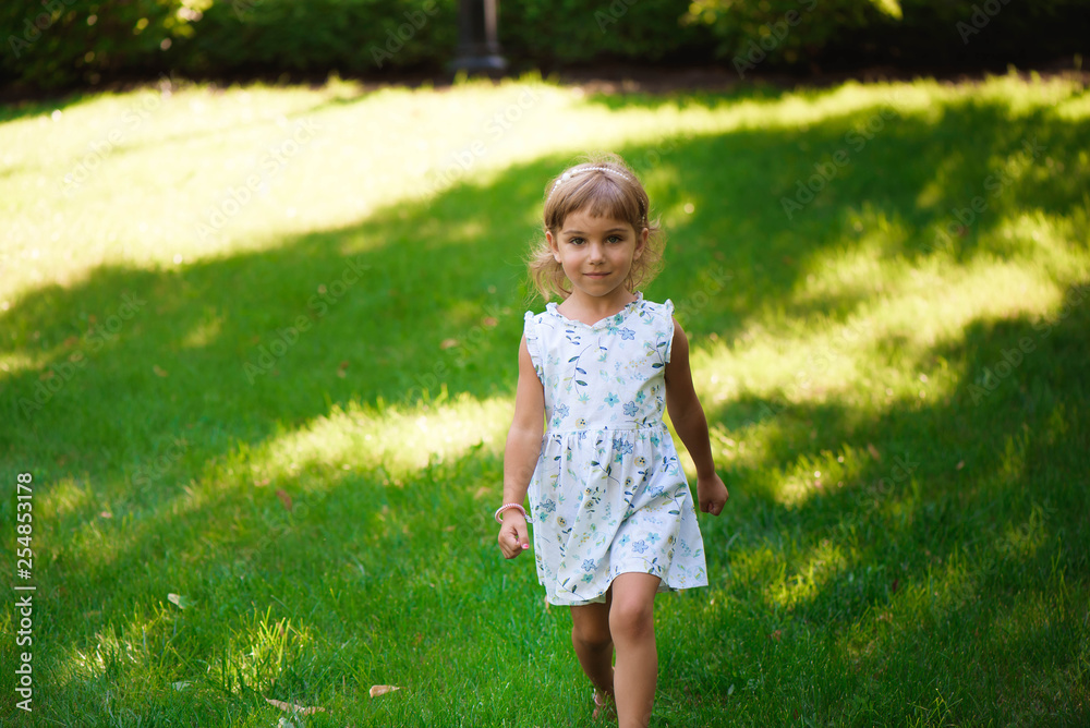 Sweet little girl outdoors with curly hair in the wind. Sweet little girl outdoors with curly hair in the wind.