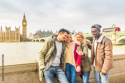 Happy multiracial friends group using smartphone in London © william87