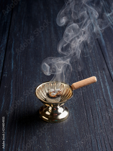 Fotografie, Obraz Burning incense in a simple Romanian orthodox censer or incense burner