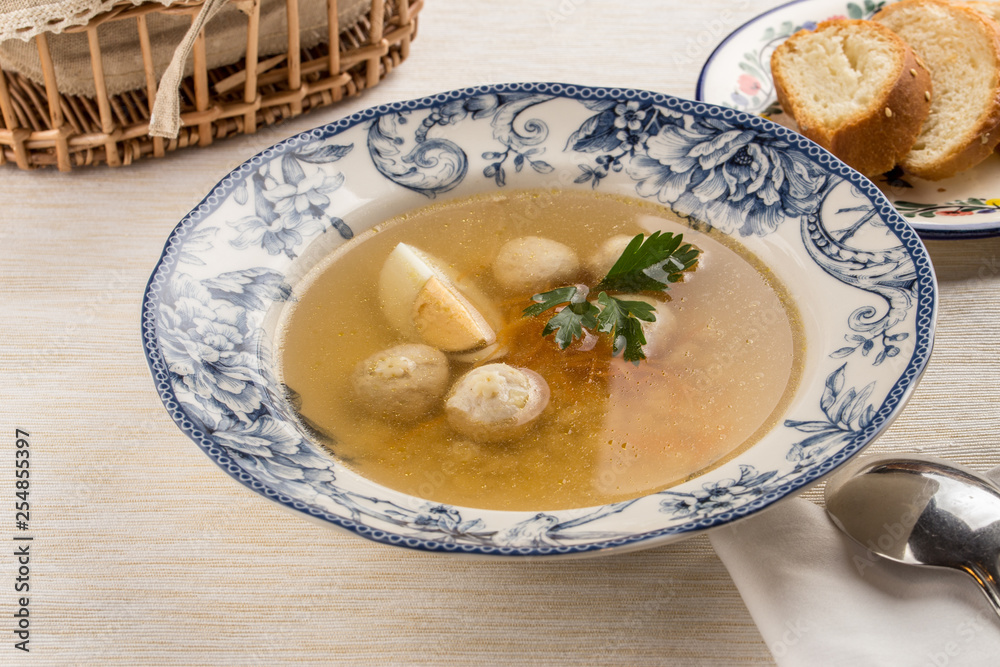 Dietary soup with chicken and egg on wooden table Dietary soup with chicken and egg on wooden table