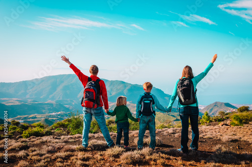 happy mom and dad with kids travel in mountains, family enjoy hiking