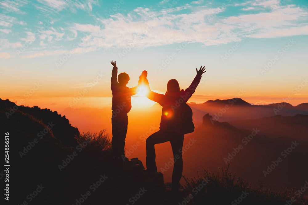 happy mother and son travel in mountains at sunset