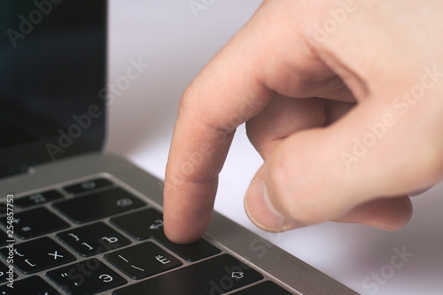 Man hand press enter laptop keyboard with white background