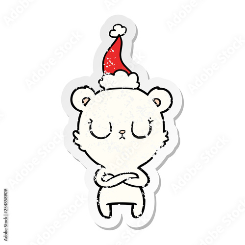 peaceful distressed sticker cartoon of a polar bear wearing santa hat