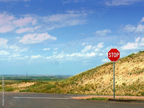 Stop sign on the road side at the Badlands National Park in South Dakota.