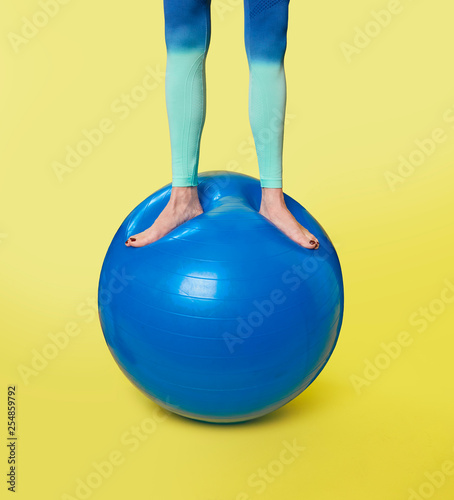 Woman standing on gym ball