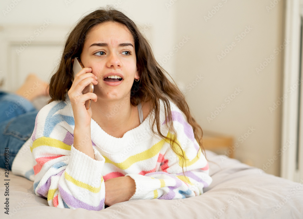 Portrait of young beautiful girl talking and chatting with friends on smart mobile phone Portrait of young beautiful girl talking and chatting with friends on smart mobile phone