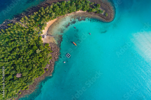 Aerial view of idyllic tranquil sea island deep blue turquoise water