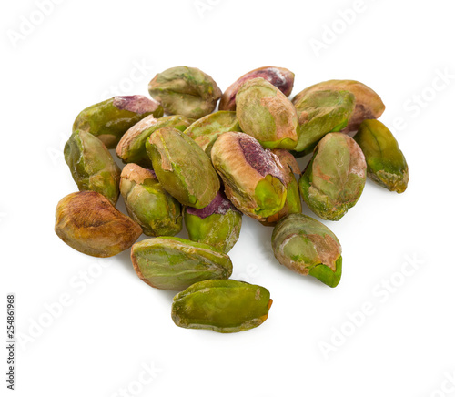 peeled pistachio nuts isolated on white