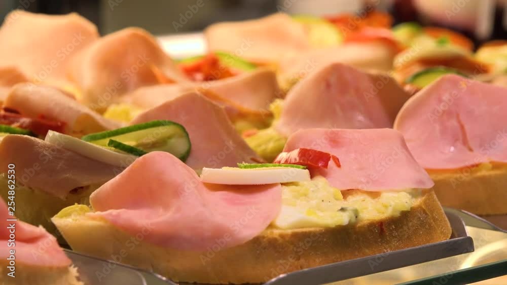 Closeup on open-face sandwiches on display on a counter in a store Closeup on open-face sandwiches on display on a counter in a store