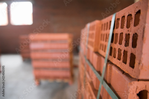 Stack of red clay brick on construction site