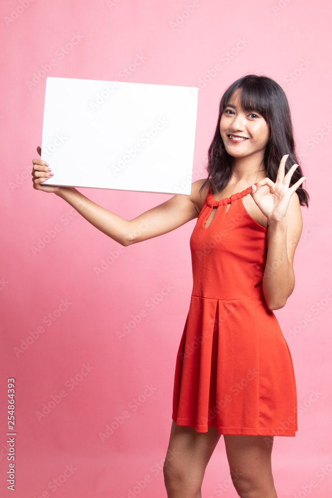 Young Asian woman show OK with  white blank sign.