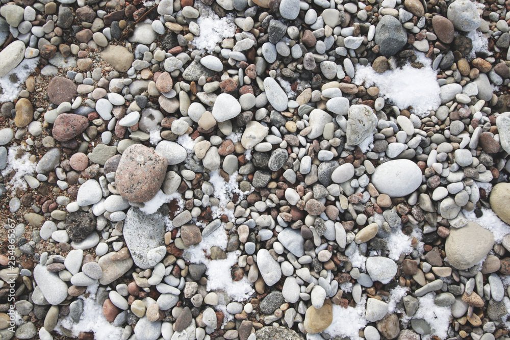 pebbles and snow on the beach texture