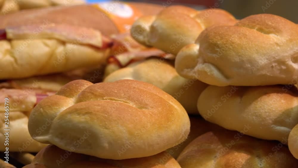 Closeup on a pile of bread rolls on a shelf in a bakery Closeup on a pile of bread rolls on a shelf in a bakery