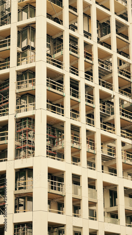 Modern apartment building under construction. Modern apartment building under construction.
