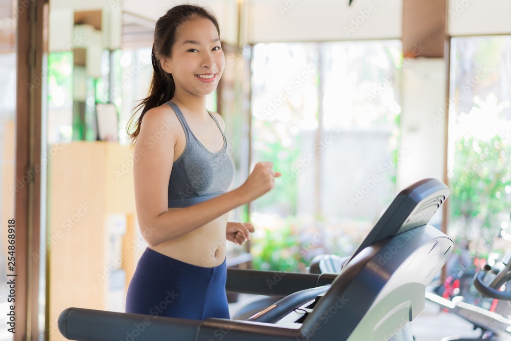 Portrait beautiful young asian woman exercise with fitness equipment in gym interior Portrait beautiful young asian woman exercise with fitness equipment in gym interior