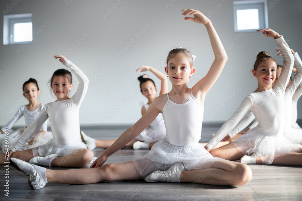 Group of little ballerinas girls doing exercises in dance school Group of little ballerinas girls doing exercises in dance school