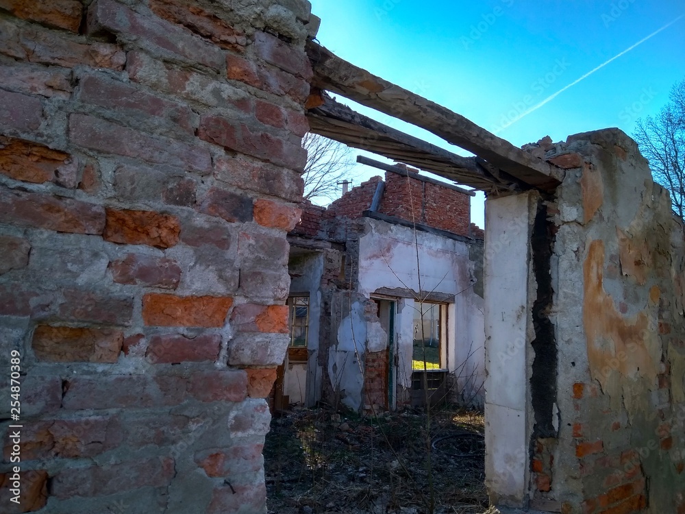 View on ruined old big house or building and blue sky in background View on ruined old big house or building and blue sky in background