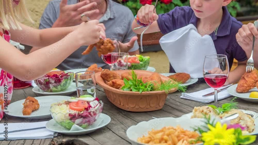 Food is in beautiful colours on the table. A young family is enjoying lunch together. Food is in beautiful colours on the table. A young family is enjoying lunch together.