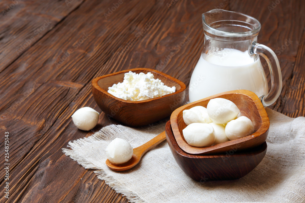 Mozzarella cheese in a wooden bowl on the table Mozzarella cheese in a wooden bowl on the table