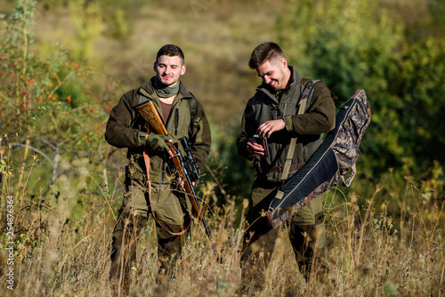 Friendship of men hunters. Man hunters with rifle gun. Boot camp. Military uniform fashion. Army forces. Camouflage. Hunting skills and weapon equipment. Hunters gamekeepers relaxing