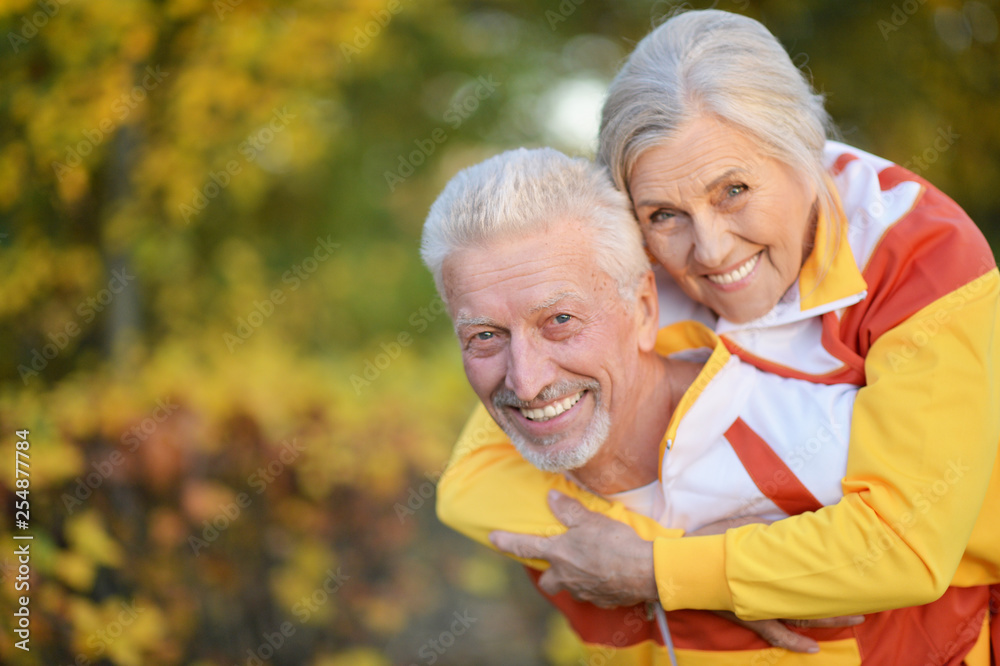Portrait of happy fit senior couple in autumn park Portrait of happy fit senior couple in autumn park