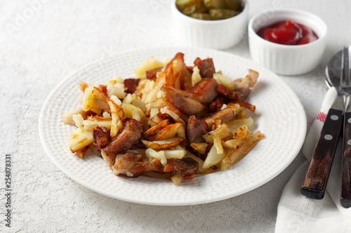 Crispy pan fried potatoes with pork, pickles and tomato ketchup sauce