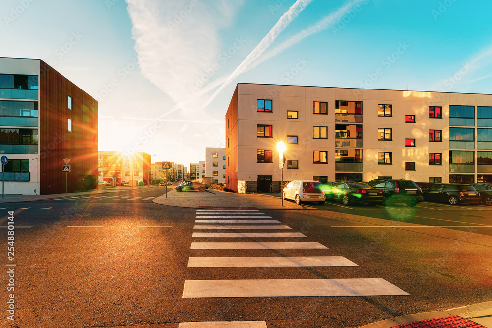 Apartment house home residential building complex street parking sunset street Stock Photo