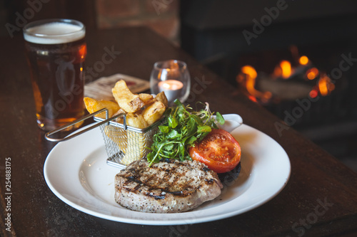 фотографія Grilled steak with chunky chips and salad