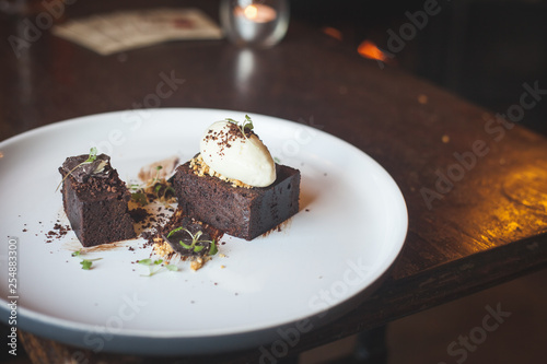 Chocolate cake with ice cream on restaurant table