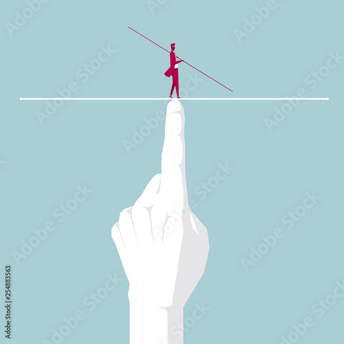 Businessman walking tightrope on the finger. Isolated on blue background.