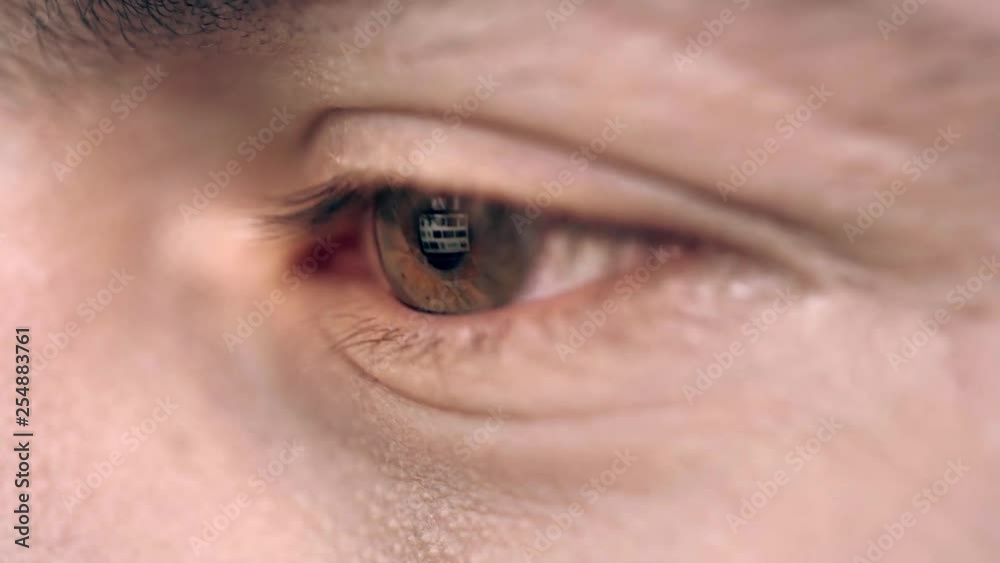 Close up view of male eye blinking and looking at something Close up view of male eye blinking and looking at something