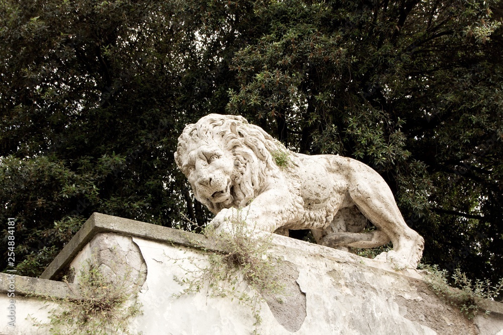 Lion sculpture in Garden of Villa Borghese. Rome, Italy. Decoration and architecture of the garden.