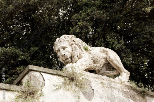 Lion sculpture in Garden of Villa Borghese. Rome  Italy. Decoration and architecture of the garden.