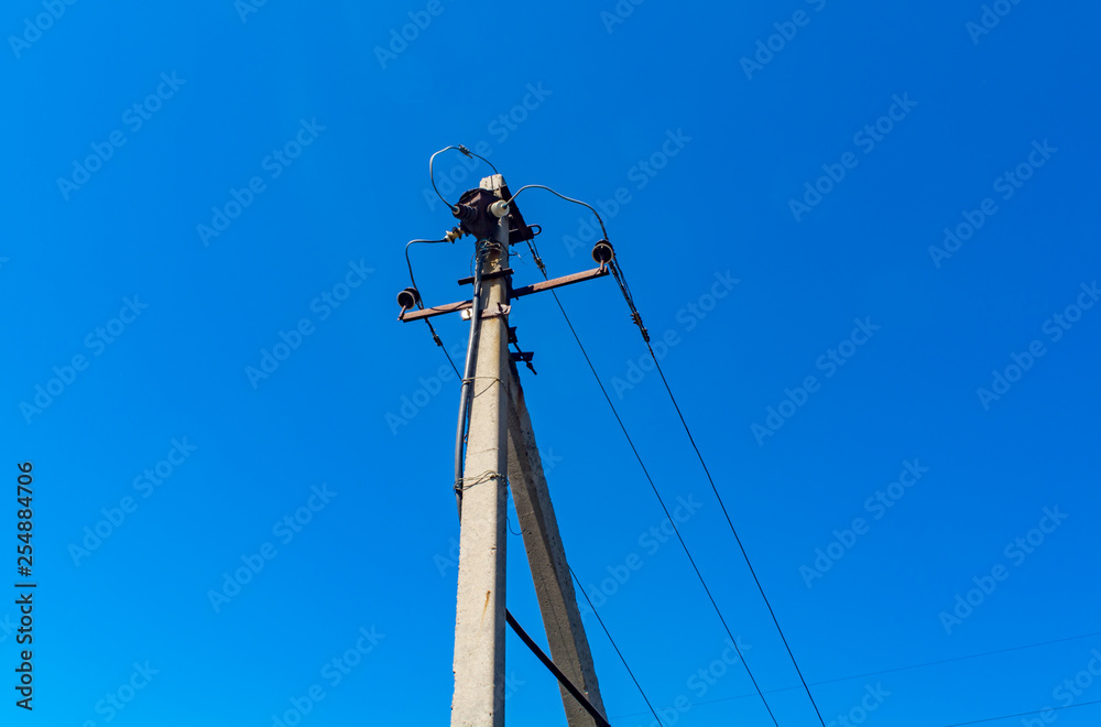 Old power line against the blue sky