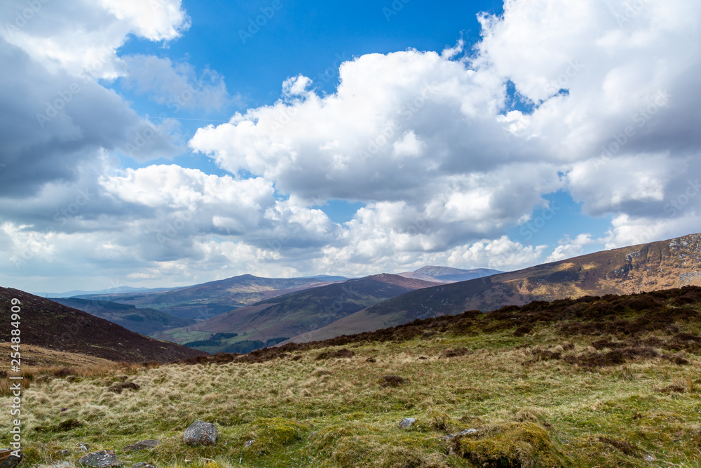 Beautiful scenic mountain landscape with clouds against the horizon in Wicklow mountains Ireland.