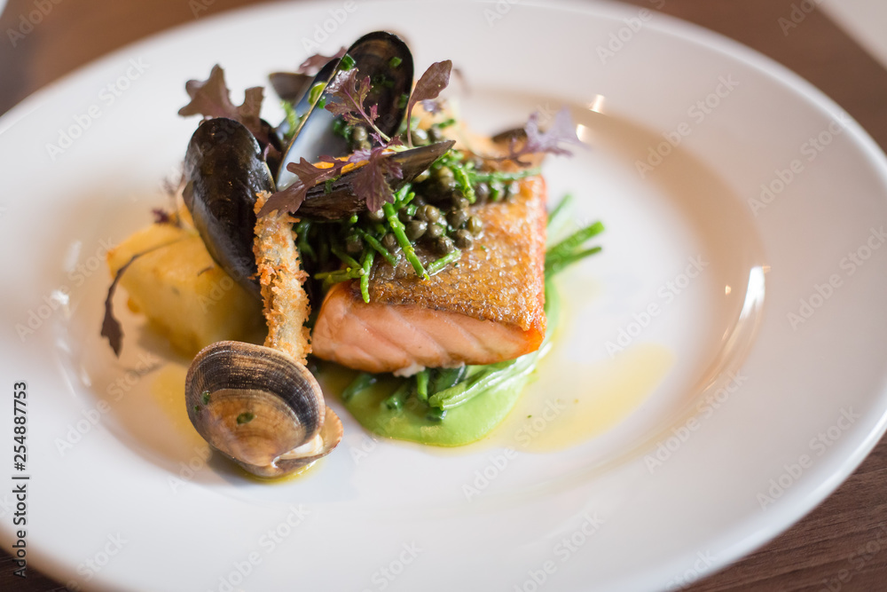 Salmon and seafood dish with potatoes and greens Salmon and seafood dish with potatoes and greens
