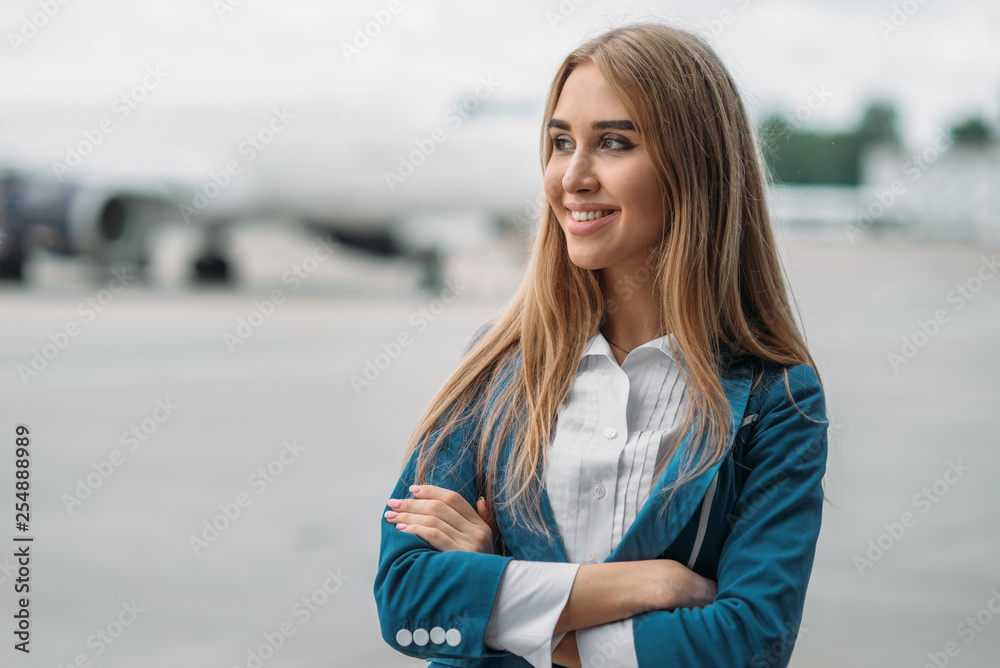 Young stewardess in uniform on aircraft parking Young stewardess in uniform on aircraft parking