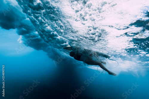 Surfer woman dive underwater. Surfgirl dive under big wave © artifirsov