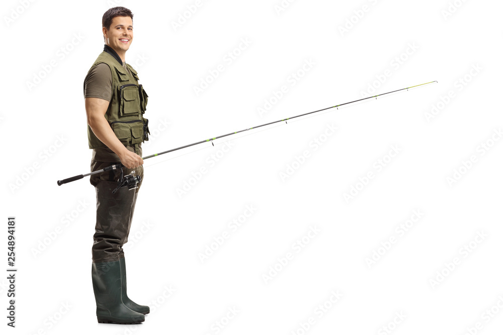 Young male fisherman with a fishing rod looking at the camera Young male fisherman with a fishing rod looking at the camera