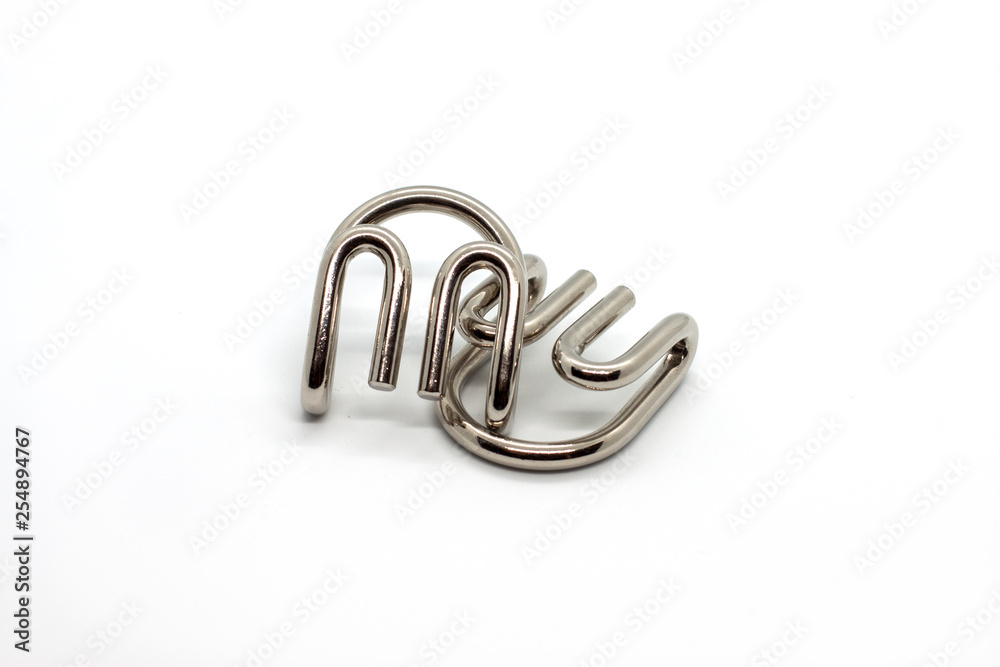 Modern metal cast puzzle Devil's claws isolated on white background Modern metal cast puzzle Devil's claws isolated on white background