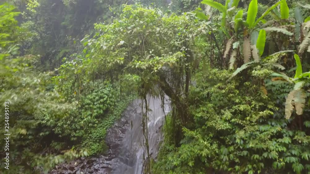 Nungnung waterfall in the middle of Bali, Indonesia. Aerial shots during an overcast day.