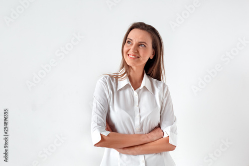Freestyle. Woman standing isolated on white crossed arms thinking creative