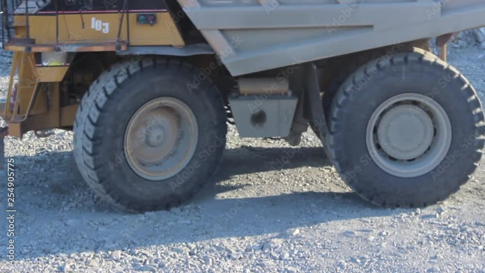 Huge career dump truck working in a career. An excavator in a quarry loads a dump truck with rock, soil, stones. Huge career dump truck working in a career. An excavator in a quarry loads a dump truck with rock, soil, stones.