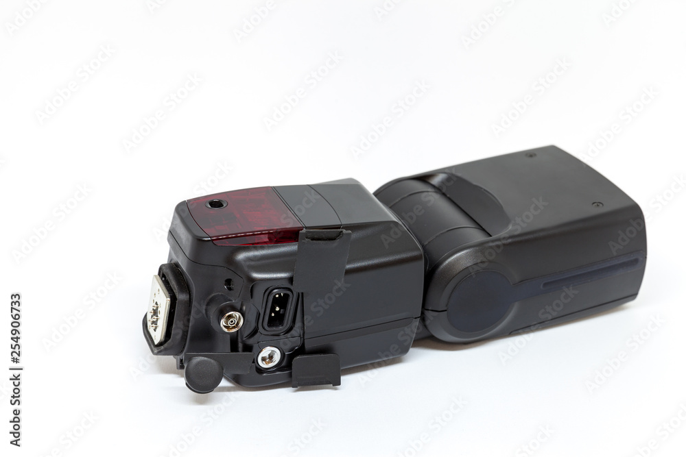 Black external flash for a camera with open additional connectors Black external flash for a camera with open additional connectors