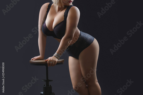  Young beautiful plus size model in underwear, xxl woman on black background