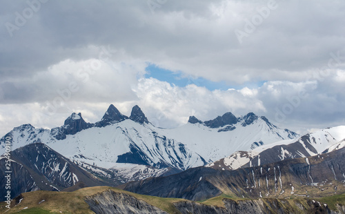 mountain peaks in spring and cloudy sky