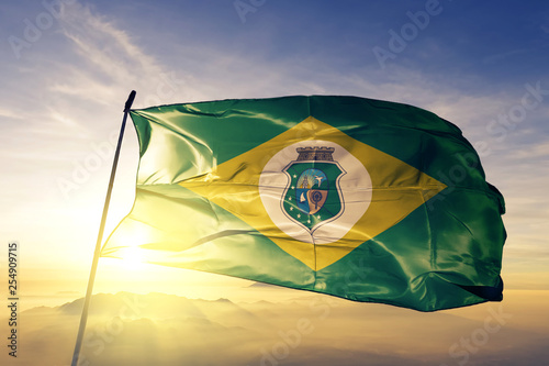 Ceara state of Brazil flag waving on the top sunrise mist fog photo