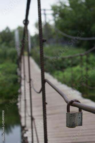 attached to welding, large padlock hanging on a suspension bridge